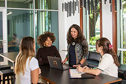 Mara Force interacting with students at table in new Center for Experiential Learning