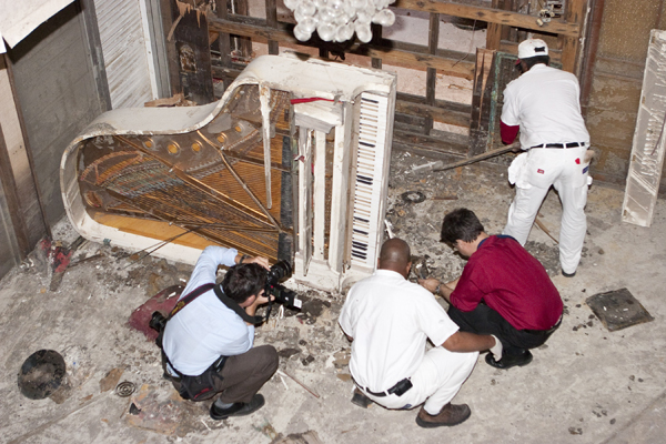 Fats Domino's white Steinway piano sits on its side in his flooded 9th Ward home following Hurricane Katrina. A class of Freeman School students created a social media campaign to raise funds for the piano's restoration and received an $18,000 donation from a fan in Australia.