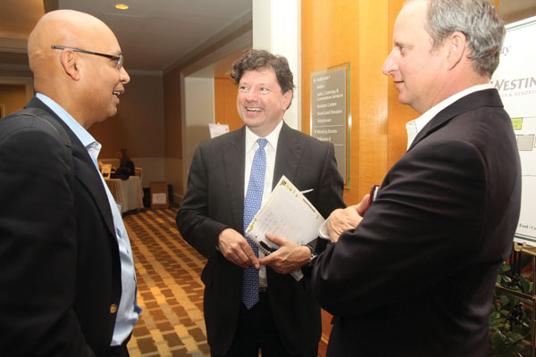 Peter Ricchiuti, center, talks with conference attendees Arvind Sanger (MBA ’87), managing partner of GeoSphere Capital Management, and Ron Mills (MBA ’95), equity analyst at Johnson Rice.