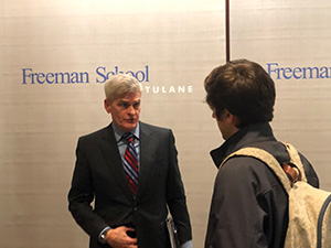 Bill Cassidy speaks to a student after his guest lecture