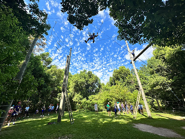 Jake Davidson (MBA ’25), a first-year MBA student fromMeridian, Mississippi, navigates the ropes course in New Orleans City Park as part of the incoming MBA cohort’s orientation program.