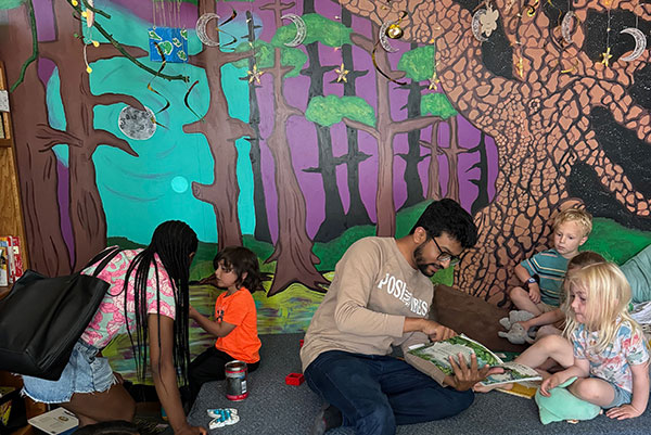 Freeman students reading to children at NOLA Nature School