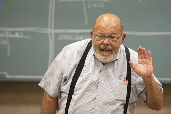 Beau Parent in front of blackboard teaching a class