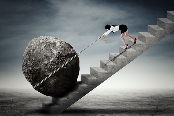 stock illustration of woman pulling boulder up stairs