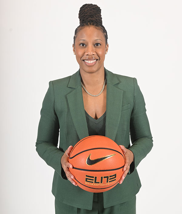 Ashley Langford portrait in green suit holding basketball