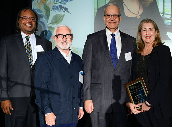 Sanda Groom receives award at Aububon Tea Room with Dean Goes, Albert Lepage and Erick Valentine. 