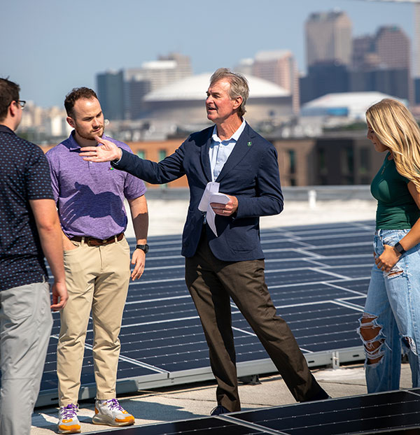 Pierre Conner shows students solar panels on roof of Howard-Tilton Library.