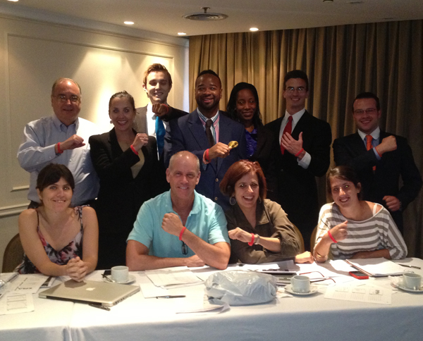 Students and officials from EMA, which works to improve the quality of life for people with multiple sclerosis, show off the wristbands the students recommended to increase awareness of the organization and its work.