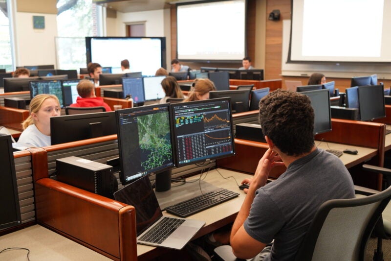 Image of students at work stations in the Freeman School trading room.