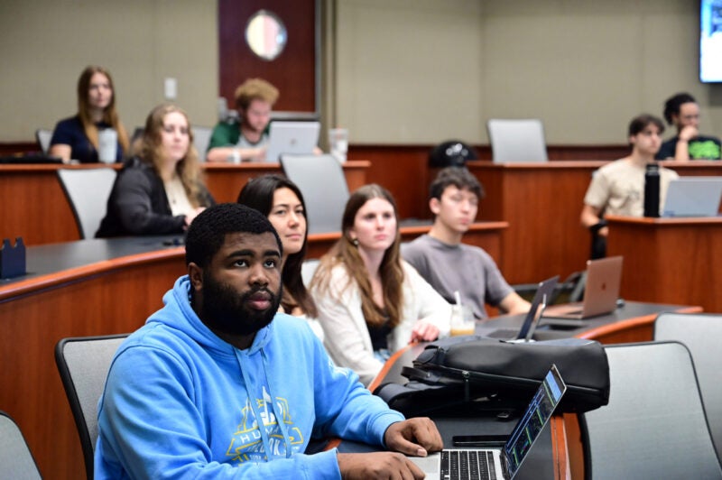 Photo of graduate students watching professor in a Freeman School classroom.